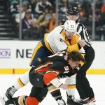 
              Nashville Predators' Tanner Jeannot, center, fights with Anaheim Ducks' Sam Carrick, bottom, during the first period of an NHL hockey game Monday, March 21, 2022, in Anaheim, Calif. (AP Photo/Jae C. Hong)
            