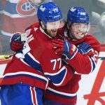 
              Montreal Canadiens' Brett Kulak (77) celebrates with Cole Caufield after scoring against the Ottawa Senators during the third period of an NHL hockey game Saturday, March 19, 2022, in Montreal. (Graham Hughes/The Canadian Press via AP)
            