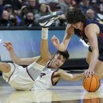 
              Gonzaga's Chet Holmgren, left, and Saint Mary's Kyle Bowen (14) scramble for the ball during the second half of an NCAA college basketball championship game at the West Coast Conference tournament Tuesday, March 8, 2022, in Las Vegas. (AP Photo/John Locher)
            