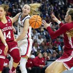
              Indiana guard Ali Patberg (14) passes the ball to guard Nicole Cardano-Hillary (4) against Connecticut guard Paige Bueckers (5) during the third quarter of a college basketball game in the Sweet Sixteen round of the NCAA women's tournament, Saturday, March 26, 2022, in Bridgeport, Conn. (AP Photo/Frank Franklin II)
            