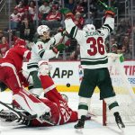 
              Minnesota Wild center Joel Eriksson Ek (14) and Mats Zuccarello (36) celebrate a Kirill Kaprizov goal against the Detroit Red Wings in the third period of an NHL hockey game Thursday, March 10, 2022, in Detroit. (AP Photo/Paul Sancya)
            