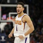 
              Phoenix Suns guard Devin Booker celebrates during the second half of the team's NBA basketball game against the Minnesota Timberwolves on Wednesday, March 23, 2022, in Minneapolis. (AP Photo/Andy Clayton-King)
            