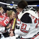 
              Ohio State's Sara Saekkinen, left, kisses the NCAA Frozen Four Hockey championship trophy held by teammate Liz Schepers (21) after they defeated Minnesota-Duluth, Sunday, March 20, 2022, in State College, Pa. (AP Photo/Gary M. Baranec)
            