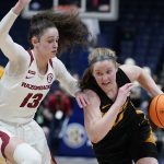 
              Missouri's Hayley Frank, right, drives against Arkansas' Sasha Goforth (13) in the first half of an NCAA college basketball game at the women's Southeastern Conference tournament Thursday, March 3, 2022, in Nashville, Tenn. (AP Photo/Mark Humphrey)
            