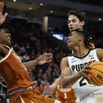 
              Texas's Marcus Carr fouls Purdue's Jaden Ivey during the second half of a second-round NCAA college basketball tournament game Sunday, March 20, 2022, in Milwaukee. Purdue won 81-71. (AP Photo/Jeffrey Phelps)
            