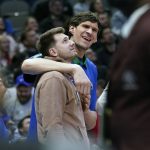 
              Dallas Mavericks center Boban Marjanovick right, jokes around with teammate Luka Doncic during a time out in the second half of an NBA basketball game in Dallas, Wednesday, March 23, 2022. The Mavericks won 110-91. (AP Photo/LM Otero)
            