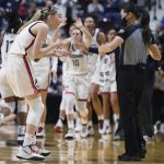 
              Connecticut's Paige Bueckers, left, talks with official Maj Forsberg during the first half of an NCAA college basketball game against Georgetown in the quarterfinals of the Big East Conference tournament at Mohegan Sun Arena, Saturday, March 5, 2022, in Uncasville, Conn. (AP Photo/Jessica Hill)
            