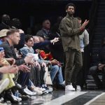 
              Brooklyn Nets' Kyrie Irving watches the game from his seats during the second half of the NBA basketball game between the Brooklyn Nets and the New York Knicks at the Barclays Center, Sunday, Mar. 13, 2022, in New York. The Nets defeated the Knicks 110-107. (AP Photo/Seth Wenig)
            