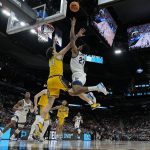 
              Villanova forward Jermaine Samuels shoots over Michigan forward Brandon Johns Jr. during the first half of a college basketball game in the Sweet 16 round of the NCAA tournament on Thursday, March 24, 2022, in San Antonio. (AP Photo/David J. Phillip)
            