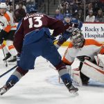
              Colorado Avalanche right wing Valeri Nichushkin, left, shoots against Philadelphia Flyers goaltender Carter Hart in the first period of an NHL hockey game Friday, March 25, 2022, in Denver. (AP Photo/David Zalubowski)
            