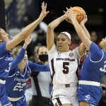 
              South Carolina forward Victaria Saxton (5) looks to pass while Creighton forward Emma Ronsiek, left, guard Carly Bachelor (22) and guard Payton Brotzki (33) apply pressure during the first half of a college basketball game in the Elite 8 round of the NCAA tournament in Greensboro, N.C., Sunday, March 27, 2022. (AP Photo/Gerry Broome)
            