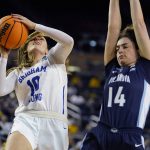 
              BYU guard Tegan Graham (10) attempts a shot as Villanova forward Brianna Herlihy (14) defends during the second half of a college basketball game in the first round of the NCAA tournament, Saturday, March 19, 2022, in Ann Arbor, Mich. (AP Photo/Carlos Osorio)
            