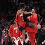 
              Houston Rockets' Jalen Green (0) celebrates with teammates after making a basket against the Los Angeles Lakers during overtime of an NBA basketball game Wednesday, March 9, 2022, in Houston. The Rockets won 139-130 in overtime. (AP Photo/David J. Phillip)
            