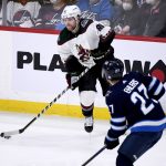 
              Arizona Coyotes' Phil Kessel (81) passes the puck past Winnipeg Jets' Nikolaj Ehlers (27) during the second period of an NHL hockey game Sunday, March 27, 2022 in Winnipeg, Manitoba. (Fred Greenslade/The Canadian Press via AP)
            