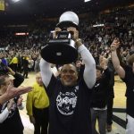 
              Providence head coach Ed Cooley raises the trophy after winning the Big East regular season title following an NCAA college basketball game against Creighton, Saturday, Feb. 26, 2022, in Providence, R.I. (AP Photo/Stew Milne)
            