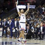 
              Connecticut's Tyrese Martin (4) celebrates during the first half of an NCAA college basketball game against DePaul Saturday, March 5, 2022, in Storrs, Conn. (AP Photo/Stew Milne)
            