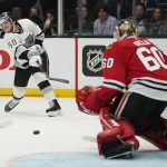 
              Los Angeles Kings defenseman Sean Durzi (50) shoots against Chicago Blackhawks goaltender Collin Delia (60) during overtime of an NHL hockey game Thursday, March 24, 2022, in Los Angeles. (AP Photo/Ashley Landis)
            