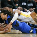 
              Orlando Magic guard Cole Anthony, lower left goes after a loose ball in front of Golden State Warriors forward Otto Porter Jr. during the second half of an NBA basketball game, Tuesday, March 22, 2022, in Orlando, Fla. (AP Photo/John Raoux)
            