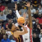 
              Ohio State's Eugene Brown III, right, defends as Loyola of Chicago's Lucas Williamson shoots during the first half of a college basketball game in the first round of the NCAA tournament, Friday, March 18, 2022, in Pittsburgh. (AP Photo/Keith Srakocic)
            