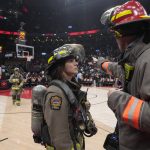 
              The NBA basketball game between the Toronto Raptors and the Indiana Pacers is suspended as firefighters work to evacuate the building, during the first half Saturday, March 26, 2022, in Toronto. (Frank Gunn/The Canadian Press via AP)
            