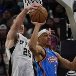 
              Oklahoma City Thunder forward Darius Bazley (7) is blocked by San Antonio Spurs center Jakob Poeltl (25) as he tries to pass the ball during the second half of an NBA basketball game, Wednesday, March 16, 2022, in San Antonio. (AP Photo/Eric Gay)
            