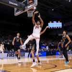 
              Rutgers' Ron Harper Jr. (24) shoots over Notre Dame's Paul Atkinson Jr. during the first half of a First Four game in the NCAA men's college basketball tournament Wednesday, March 16, 2022, in Dayton, Ohio. (AP Photo/Aaron Doster)
            