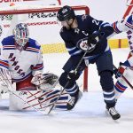 
              New York Rangers goaltender Igor Shesterkin (31) makes a save against Winnipeg Jets' Blake Wheeler (26) during the first period of NHL hockey game action in Winnipeg, Manitoba, Sunday, March 6, 2022.  (Fred Greenslade/The Canadian Press via AP)
            