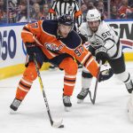 
              Los Angeles Kings' Sean Durzi (50) chases Edmonton Oilers' Connor McDavid (97) during the second period of an NHL hockey game Wednesday, March 30, 2022, in Edmonton, Alberta. (Jason Franson/The Canadian Press via AP)
            