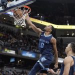 
              Memphis Grizzlies' De'Anthony Melton (0) dunks during the second half of an NBA basketball game against the Indiana Pacers, Tuesday, March 15, 2022, in Indianapolis. (AP Photo/Darron Cummings)
            