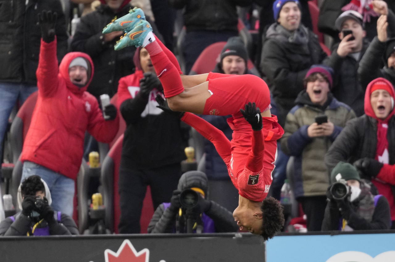 Canada's Tajon Buchanan does a backflip after scoring against Jamaica during first-half CONCACAF Wo...
