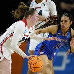 
              Dayton guard Erin Whalen (21) drives past DePaul guard Sonya Morris (11) during the first half of a First Four game in the NCAA women's college basketball tournament, Wednesday, March 16, 2022, in Ames, Iowa. (AP Photo/Charlie Neibergall)
            