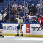 
              Buffalo Sabres left wing Jeff Skinner, center, celebrates with defenseman Rasmus Dahlin (26) after scoring against the Washington Capitals during the first period of an NHL hockey game in Buffalo, N.Y., Friday, March 25, 2022. (AP Photo/Adrian Kraus)
            