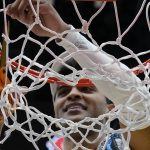 
              Kansas' Remy Martin cuts down the net after a college basketball game in the Elite 8 round of the NCAA tournament Sunday, March 27, 2022, in Chicago. Kansas won 76-50 to advance to the Final Four. (AP Photo/Nam Y. Huh)
            