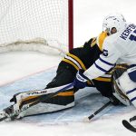 
              Toronto Maple Leafs center Alexander Kerfoot (15) pokes the puck past Boston Bruins goaltender Jeremy Swayman (1) for a goal during the first period of an NHL hockey game, Tuesday, March 29, 2022, in Boston. (AP Photo/Charles Krupa)
            