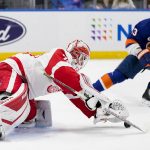 
              Detroit Red Wings goaltender Alex Nedeljkovic (39) makes a save against New York Islanders center Casey Cizikas (53) in the second period of an NHL hockey game, Thursday, March 24, 2022, in Elmont, N.Y. (AP Photo/John Minchillo)
            