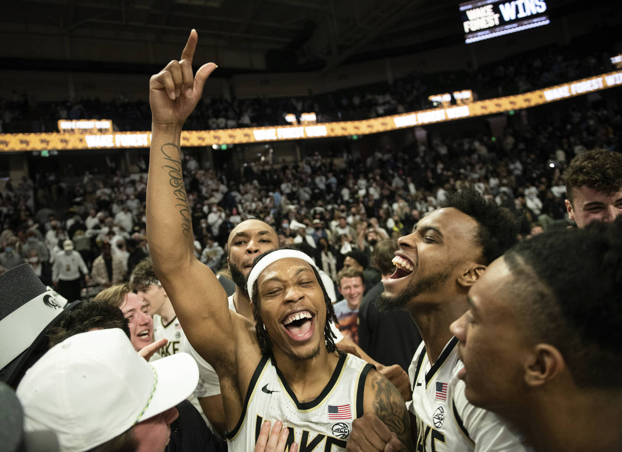 FILE - Wake Forest guard Alondes Williams, center left, and forward Isaiah Mucius, center right, ce...