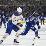 
              Toronto Maple Leafs forward Mitchell Marner (16) chases down the loose puck against Buffalo Sabres defenseman Rasmus Dahlin (26) during the second period of an NHL hockey game Wednesday, March 2, 2022 in Toronto. (Nathan Denette/The Canadian Press via AP)
            