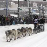 
              Five-time winner Dallas Seavey takes his sled dog team through a snowstorm in downtown Anchorage, Alaska, on Saturday, March 5, 2022, during the ceremonial start of the Iditarod Trail Sled Dog Race. The competitive start of the nearly 1,000-mile race will be held March 6, 2022, in Willow, Alaska, with the winner expected in the Bering Sea coastal town of Nome about nine days later. (AP Photo/Mark Thiessen)
            