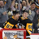
              Pittsburgh Penguins' Jake Guentzel (59) celebrates his goal with Sidney Crosby, who assisted, during the second period of the team's NHL hockey game against the Columbus Blue Jackets in Pittsburgh, Tuesday, March 22, 2022. (AP Photo/Gene J. Puskar)
            
