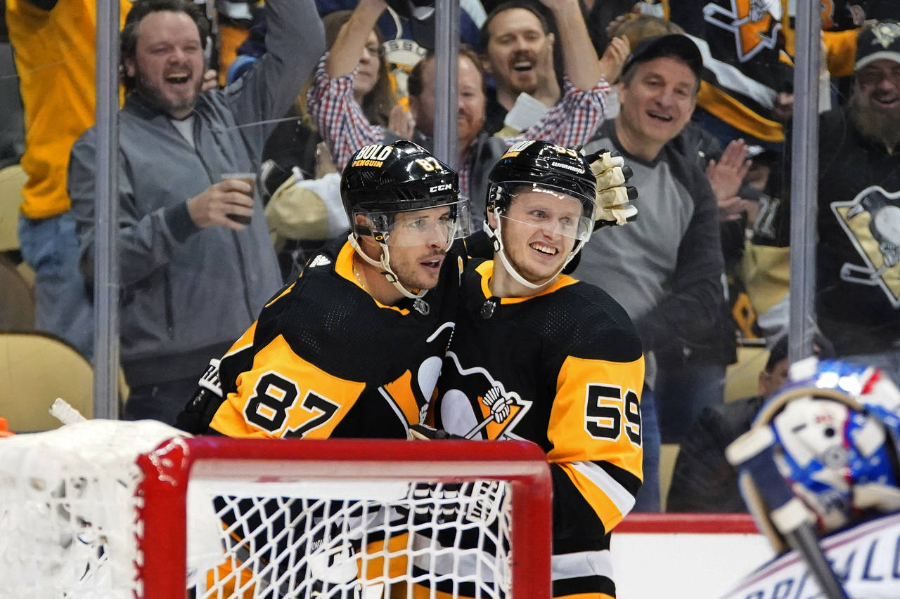 Pittsburgh Penguins' Jake Guentzel (59) celebrates his goal with Sidney Crosby, who assisted, durin...