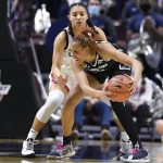 
              Connecticut's Azzi Fudd, back, guards Georgetown's Jillian Archer in the first half of an NCAA college basketball game in the quarterfinals of the Big East Conference tournament at Mohegan Sun Arena, Saturday, March 5, 2022, in Uncasville, Conn. (AP Photo/Jessica Hill)
            