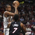 
              Brooklyn Nets forward Nic Claxton, left, grabs a rebound over Miami Heat guard Kyle Lowry (7) during the first half of an NBA basketball game Saturday, March 26, 2022, in Miami. (AP Photo/Jim Rassol)
            