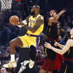 
              Los Angeles Lakers' LeBron James (6) shoots against Cleveland Cavaliers' Lamar Stevens (8) and Lauri Markkanen (24) during the first half of an NBA basketball game, Monday, March 21, 2022, in Cleveland. (AP Photo/Ron Schwane)
            