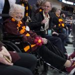 
              Loyola of Chicago team chaplain Sister Jean Dolores Schmidt, left, sits in the stands before a college basketball game between Loyola of Chicago and Ohio State in the first round of the NCAA tournament in Pittsburgh, Friday, March 18, 2022. (AP Photo/Gene J. Puskar)
            