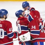 
              Montreal Canadiens goaltender Jake Allen (34) is hugged by teammates after the team's win over the Toronto Maple Leafs in an NHL hockey game Saturday, March 26, 2022, in Montreal. (Graham Hughes/The Canadian Press via AP)
            
