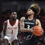
              Cincinnati guard Mike Saunders Jr. (3) drives to the basket against Houston guard Jamal Shead (1) during the first half of an NCAA college basketball game Tuesday, March 1, 2022, in Houston. (AP Photo/Justin Rex)
            