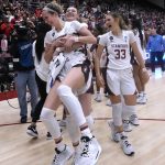 
              Stanford guard Lexie Hull (12) is hugged by teammate Cameron Brink, center, and Hannah Jump (33) after a second-round game against Kansas in the NCAA women's college basketball tournament Sunday, March 20, 2022, in Stanford, Calif. (AP Photo/Tony Avelar)
            