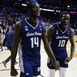 
              Saint Peter's Fousseyni Drame (10) and Hassan Drame (14) react after Saint Peter's won a college basketball game against Purdue in the Sweet 16 round of the NCAA tournament, Friday, March 25, 2022, in Philadelphia. (AP Photo/Chris Szagola)
            