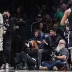 
              Brooklyn Nets' Kyrie Irving, left, looks over the court as he enters the arena during the first half of the NBA basketball game between the Brooklyn Nets and the New York Knicks at the Barclays Center, Sunday, Mar. 13, 2022, in New York. (AP Photo/Seth Wenig)
            