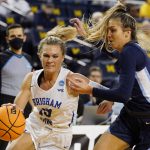 
              BYU guard Paisley Harding (13) drives as Villanova guard Bella Runyan, right, defends during the second half of a college basketball game in the first round of the NCAA tournament, Saturday, March 19, 2022, in Ann Arbor, Mich. (AP Photo/Carlos Osorio)
            